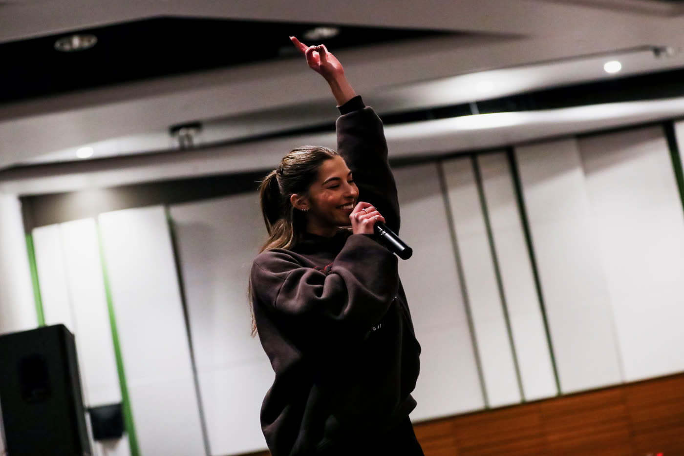 Megan emceeing a class with a microphone