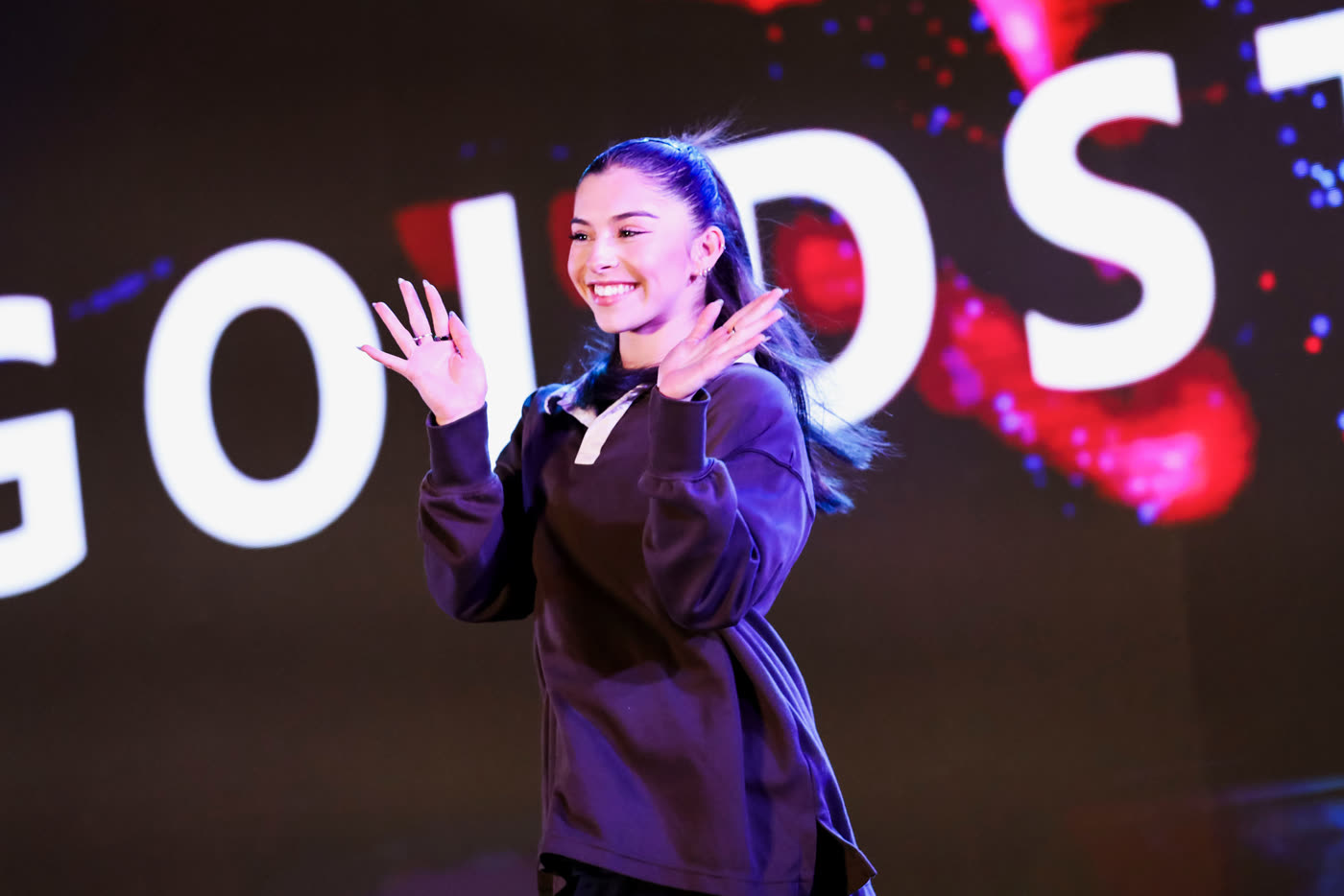 Megan on stage with her name in lights